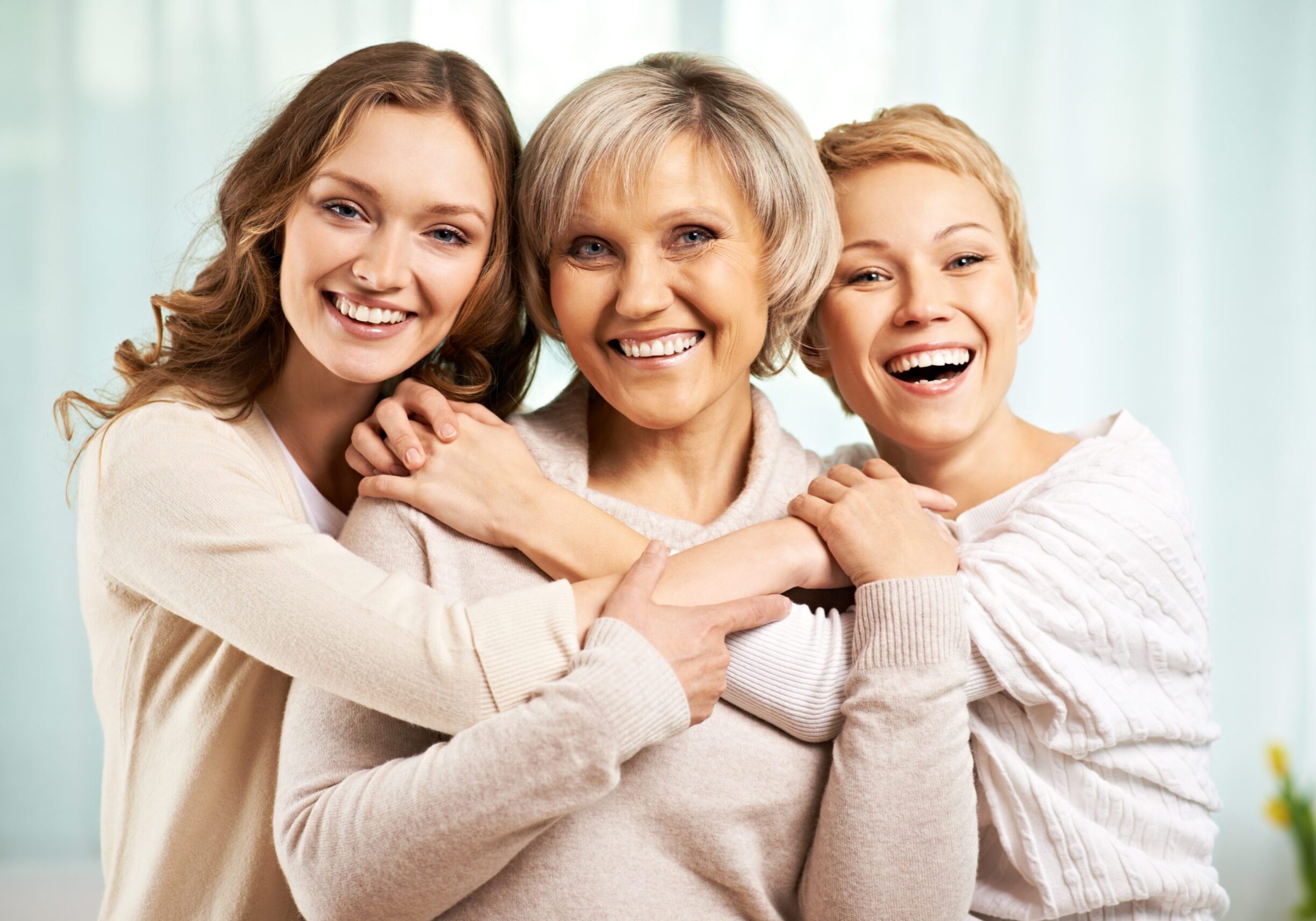 Happy family Happy family of three embracing each other and smiling at camera